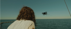Femme de dos voyant l'arrivée d'un drone